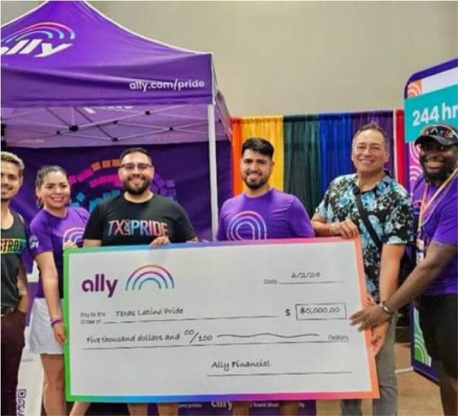 Smiling Ally Pride participants present a donation check to Texas Latino Pride.