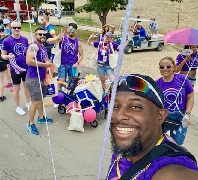 Ally Pride participants smile together for a group selfie.