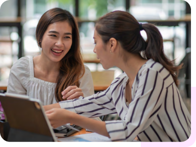 two females happily working together