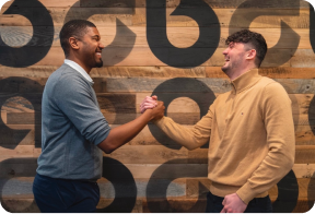 two Ally employees happily embracing each other